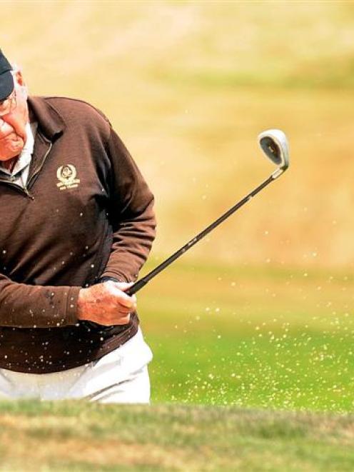 Ivan Elder, the oldest contestant in the New Zealand Masters Games, clears a bunker  at the St...