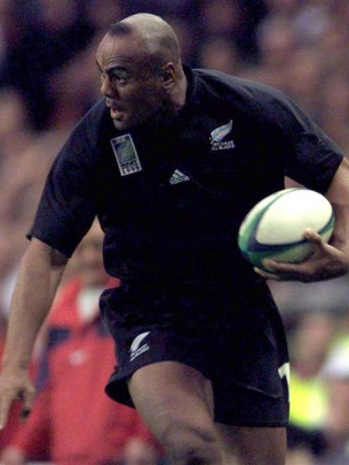 Jonah Lomu pushes past English winger Austin Healey during the 1999 Rugby World Cup at Twickenham...