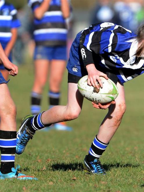 Kaikorai Under 12 Demons wing Rachael Pitts runs with the ball at the Taieri sevens tournament in...