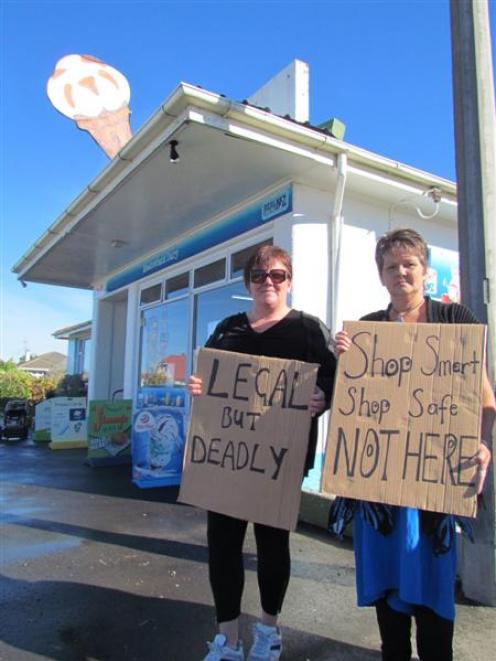 Kelly Cadogan (left), and Linda Forbes continue with their protest outside an Oamaru dairy...