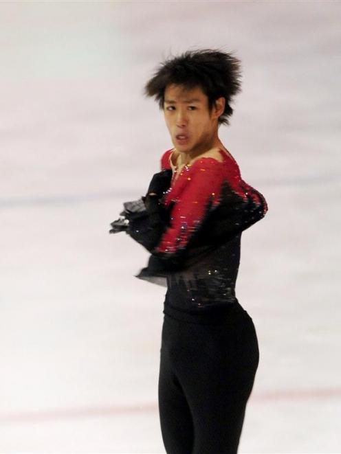 Kensuke Nakaniwa, of Japan, skates his way to gold in the senior men's figure skating at the...