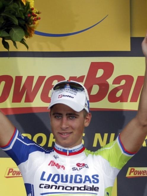 Liquigas-Cannondale rider Peter Sagan celebrates on the podium after winning the first stage of...