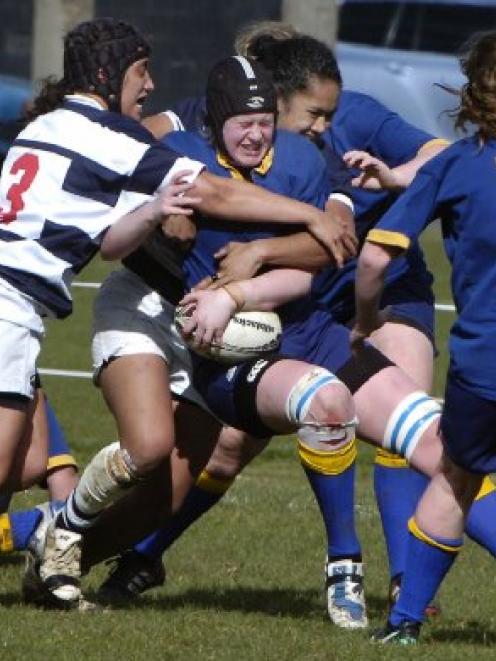 Lisa Waddell, of Otago, is tackled by Auckland defenders Karina Penetito (left) and Bella Milo...