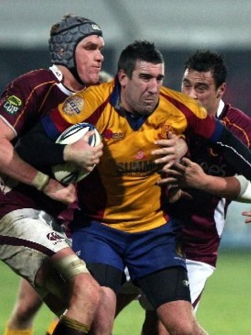 Luke Herden tries to break through the tackle of Southland lock Josh Bekhuis during North Otago's...