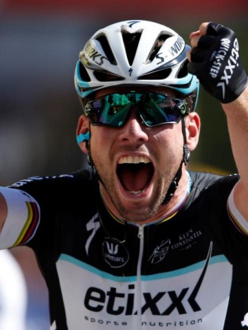 Mark Cavendish celebrates as he crosses the finish line to win the 190.5km 7th stage, from...