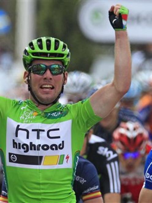 Mark Cavendish of Britain celebrates as he crosses the finish line ahead of Daniel Oss of Italy...