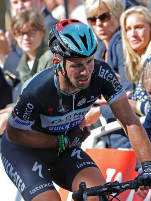 Mark Cavendish of Britain crosses the finish line after crashing in the first stage of the Tour...