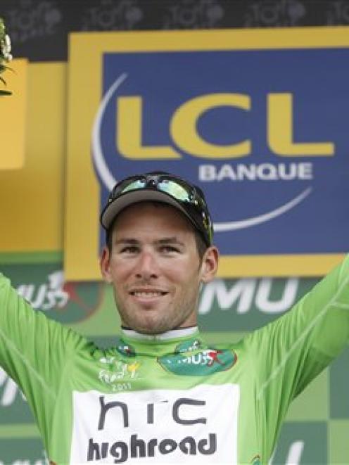 Mark Cavendish of Britain, wearing the top sprinter's green jersey, celebrates on the podium of...