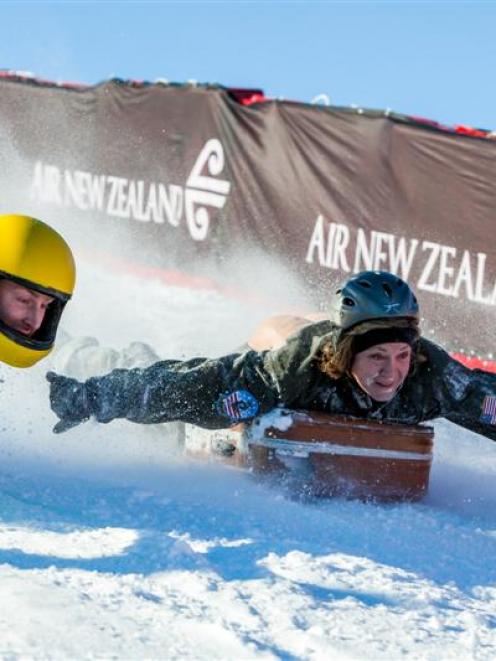 Matt Malcolm (left) and Kelly Zontine compete in  the 2012 suitcase race. Photo by Christina...