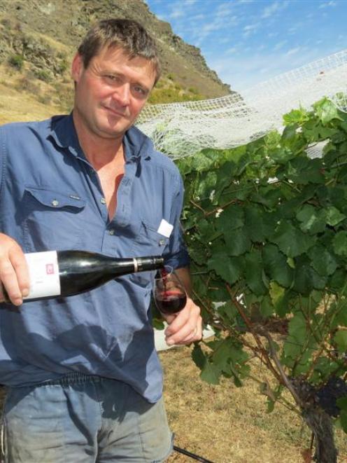 Mt Rosa co-owner Jeremy Railton samples the 2010 Mt Rosa reserve pinot noir  beside vineyards...