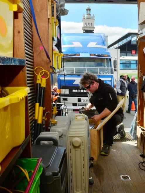 Unit manager Paul Stieglbauer sorts equipment in the film crew compound in the car park between...