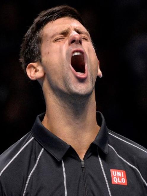 Novak Djokovic reacts after breaking Rafael Nadal's serve. REUTERS/Toby Melville