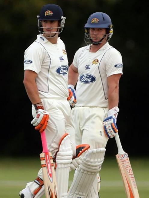 Otago batsmen neil broom (left) and Shaun Haig meet mid pitch during their unbeaten third-wicket...