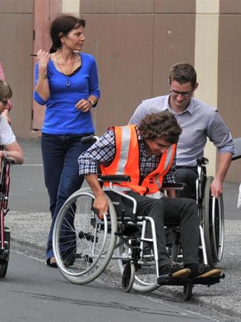 Participating in a disability trial around central Dunedin yesterday are (from left) Sam Riddell,...