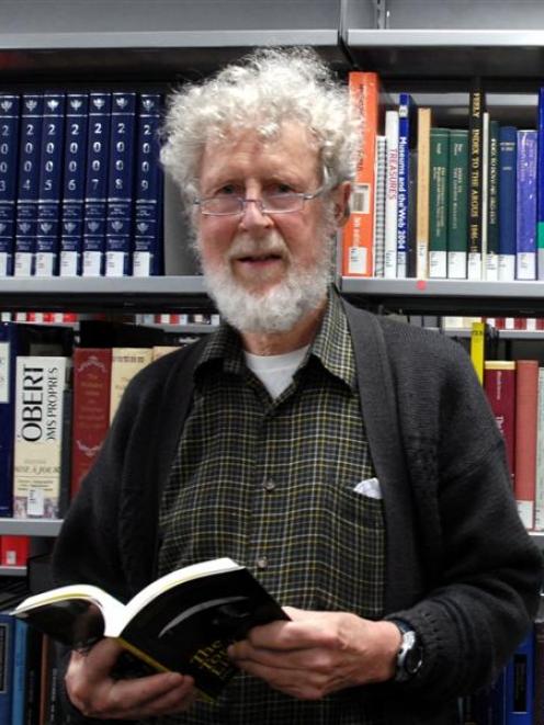 Prof Jim Flynn with a copy of his book in the University of Otago central library. Photo by...