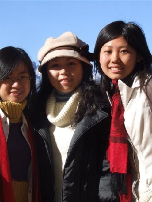 Chinese students (from left) Carol Mengxi Lin, Rachel Yunqi Zeng and Zoe Zuo stroll through...