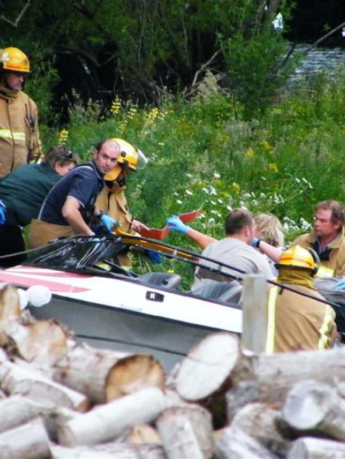 Queenstown and Frankton emergency services personnel tend to injured people aboard the jet-boat...