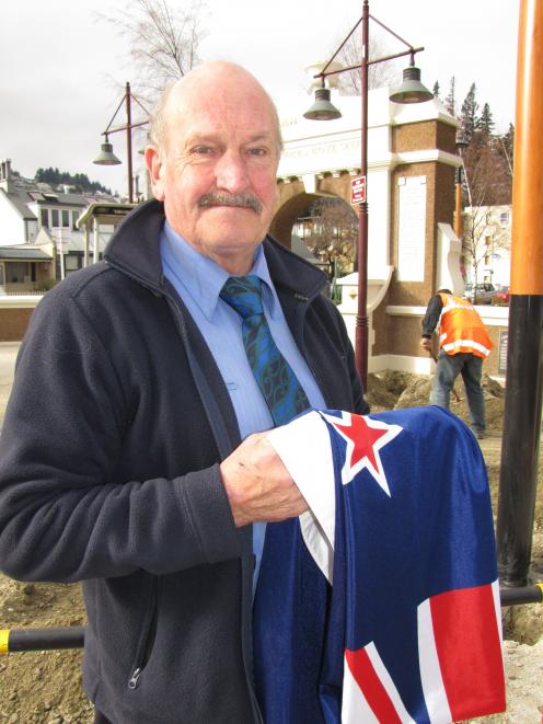 Queenstown RSA vice-president Lyall McGregor holds the New Zealand flag destined for the long...