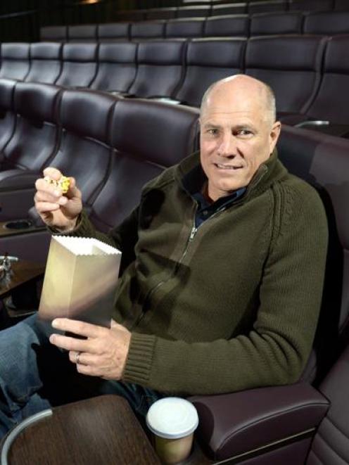 Reading Entertainment managing director Wayne Smith, of Melbourne, eats popcorn in the new...