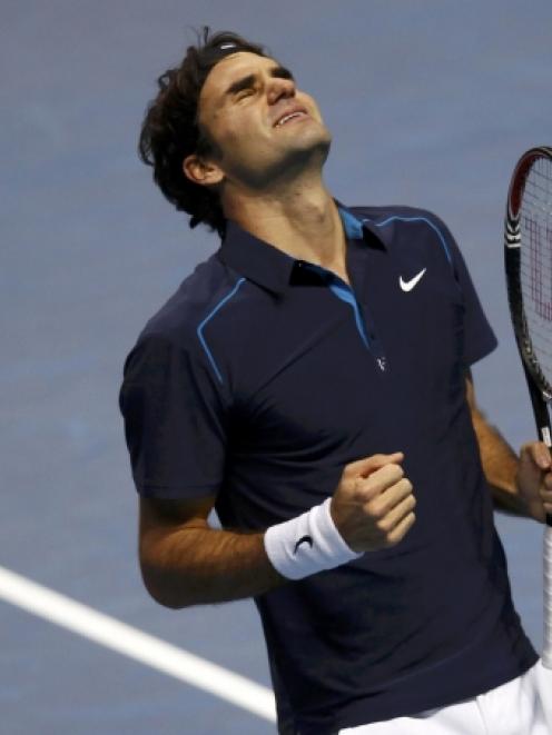 Roger Federer of Switzerland celebrates winning the men's singles final against Jo-Wilfried...