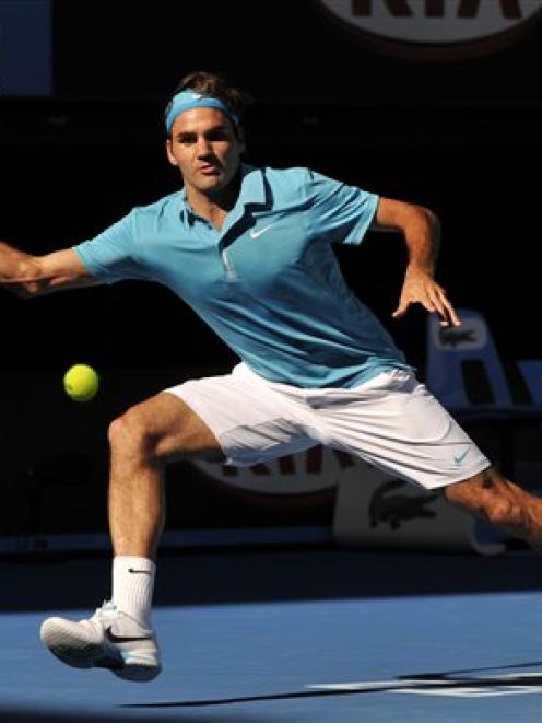 Roger Federer of Switzerland returns to Nikolay Davydenko of Russia in their Men's singles...