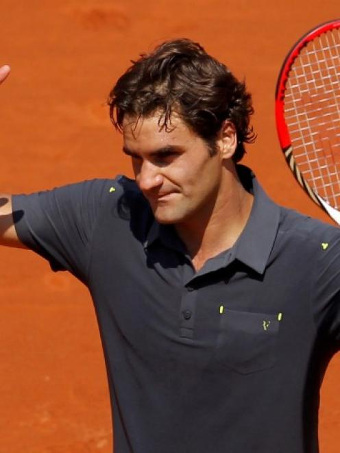 Roger Federer of Switzerland waves after winning his match against Tobias Kamke of Germany at the...