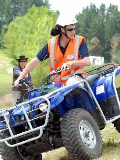 Showing how easy it is to tip a quad bike are tutors John Polstra (riding the bike), of Ag...