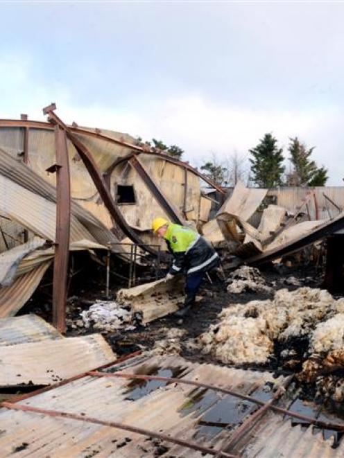 Southern region fire safety officer Barry Gibson, of Dunedin, examines the burnt wreckage of a...