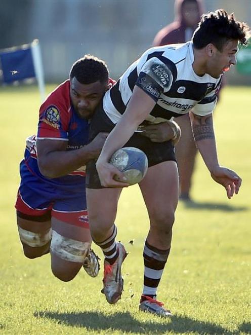 Southern winger Josh Gordon is tackled by Harbour flanker Naulia Dawai at Bathgate Park on...