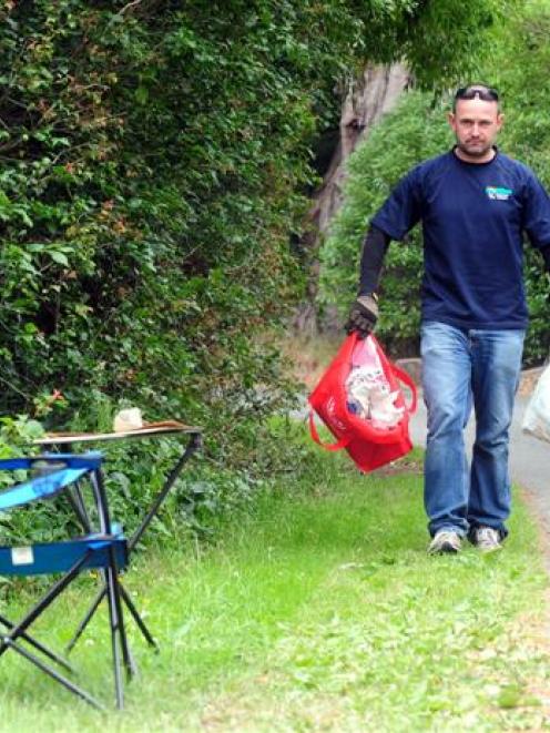 Steve  Walker collects rubbish dumped in Victory Place in Port Chalmers in this file photo. Photo...