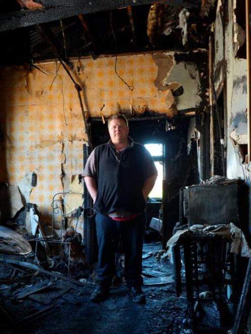 Steven Salenieks inside the charred remains of his mother's Cutten St home, which was destroyed...