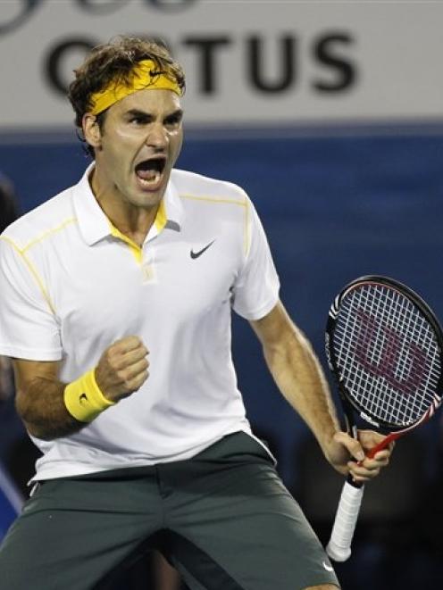 Switzerland's Roger Federer celebrates during his second round win over France's Gilles Simon at...