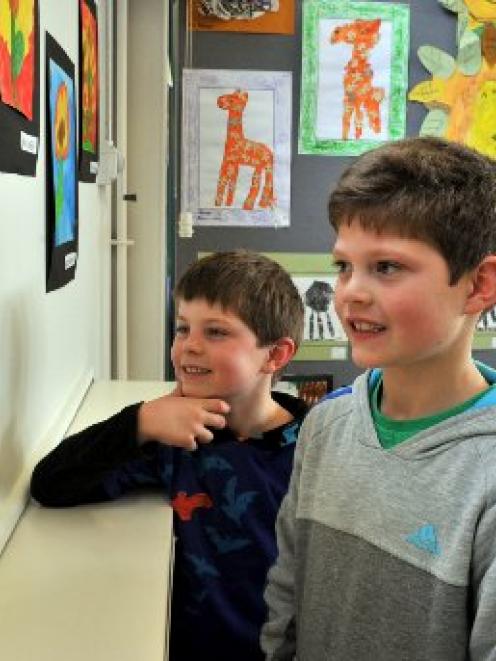 Tainui School pupils Harry (left, 5) and Jonty (7) Townsend admire Jonty's entry in the Peninsula...