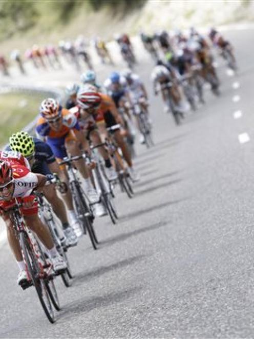 The pack speeds downhill during the 17th stage of the Tour de France from Gap, France to Pinerolo...