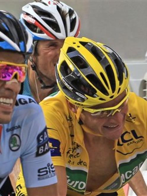 Thomas Voeckler of France, clenches his fist as he retains the yellow jersey crossing the finish...