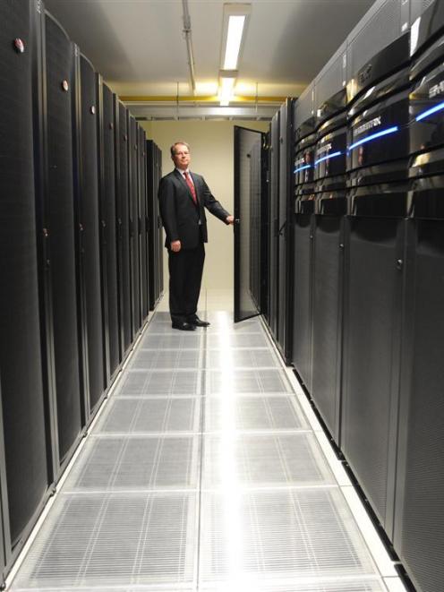 University of Otago information technology services director Mike Harte inspects one of the...