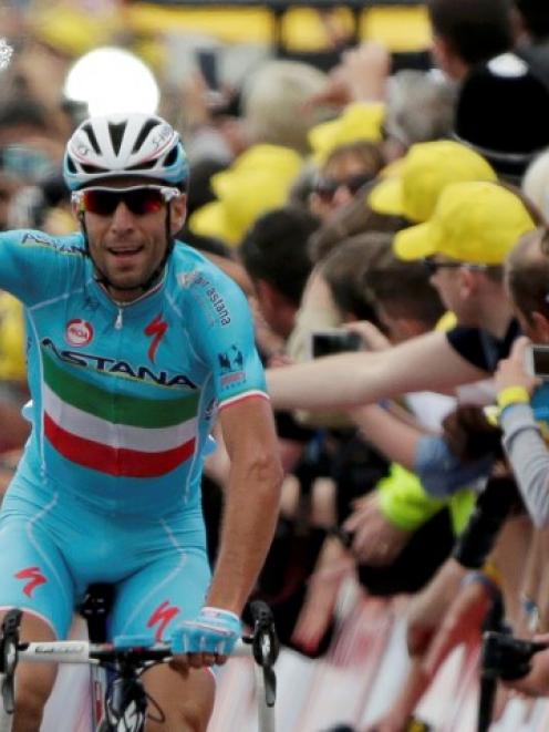 Vincenzo Nibali celebrates as he crosses the finish line to win the second stage of the Tour de...