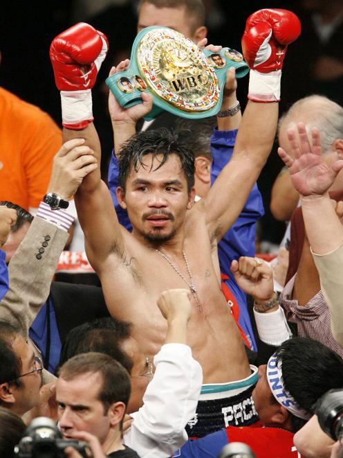 WBC lightweight champion Manny Pacquiao celebrated his victory over Oscar De La Hoya after their...
