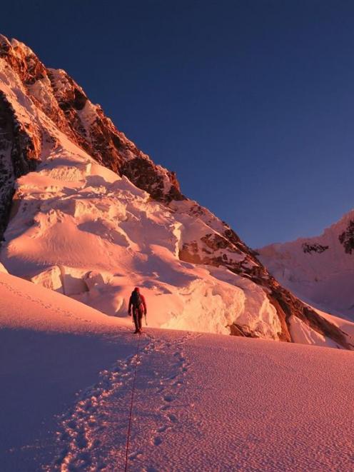 Ben Dare approaches the east face of Taulliraju, Peru, during the first ascent of the peak's East...