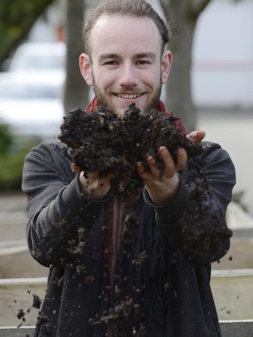 Student Finn Boyle runs his hands through some soil at the Otago Polytechnic yesterday. Photo:...