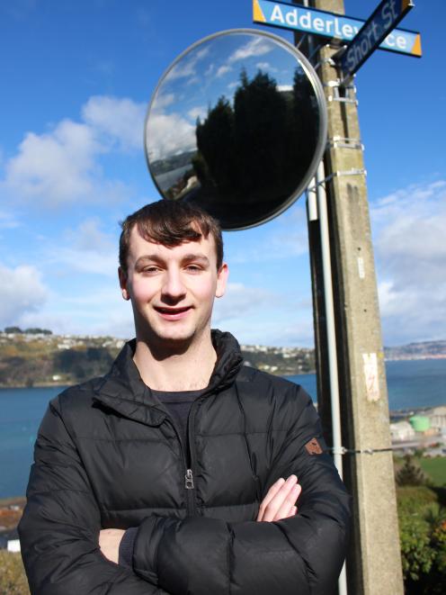 West Harbour Community Board member Ryan Jones shows off a new traffic mirror placed on the...