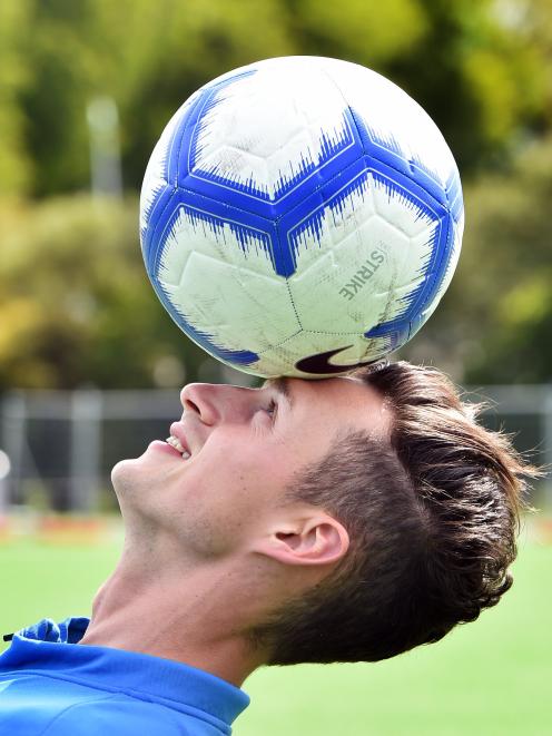 Joel Stevens plays with a football at the Logan Park turf this week. PHOTO: PETER MCINTOSH
