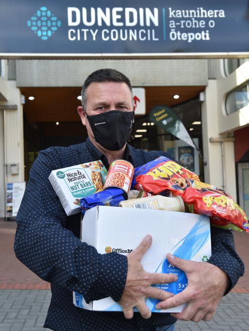 Dunedin City Council senior contract supervisor Terry Taylor holds one of the first parcels of...