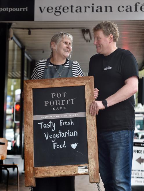 Potpourri Vegetarian Cafe’s former owners, Hilary and Craig Procter, hold its welcome sign. PHOTO...