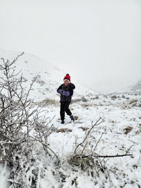 Hannah Douglas (6) plays in the first snow this winter at the base of the Lindis Pass. PHOTO:...