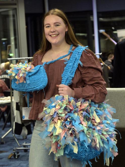 Otago Polytechnic Te Pūkenga design (fashion) student Emma Rowley models handbags she made out of...