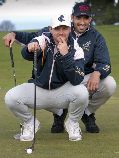 Australian lock Richie Arnold (rear) gives team-mate Dylan Pietsch a line on his putt during a...