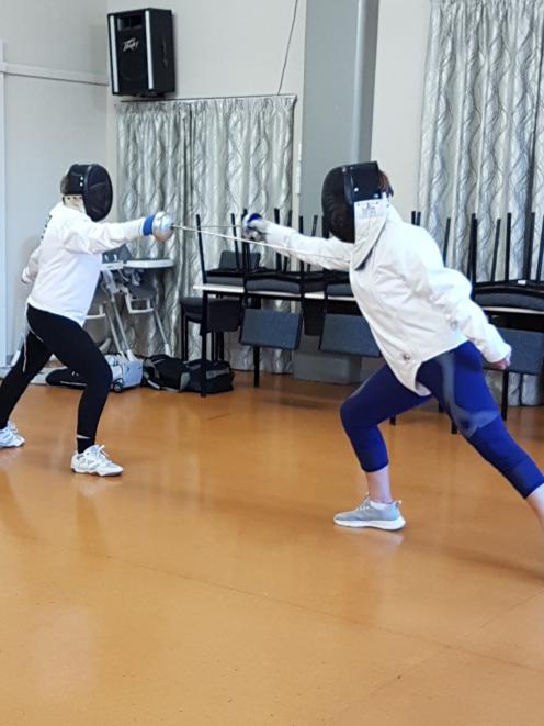 Waimate Whitehorse Lions members demonstrate the sport of fencing at the club’s meeting. PHOTO:...