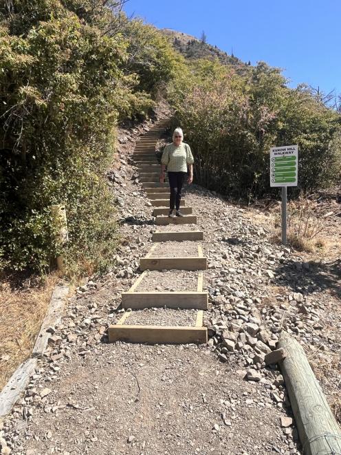 Climbing down the upgraded steps on the Kurow Hill Track is Anne McKenzie, the recent recipient...