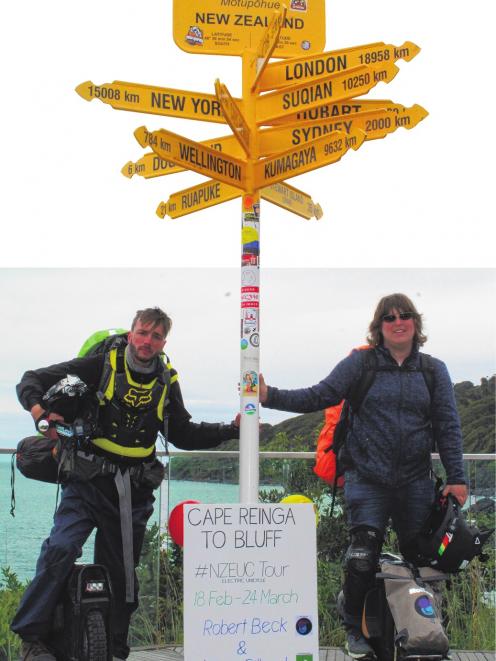 Linus Gilbert (left) and Robert Beck end their 36-day electric unicycle ride from Cape Reinga to...